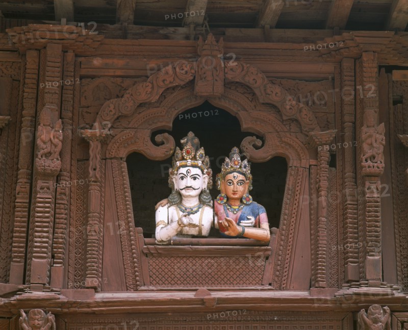 NEPAL, Kathmandu, Durbar Square.  Coloured carvings of Shiva and Parvati.
