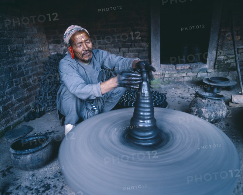 NEPAL, Bhaktapur, Local potter shaping vase on wheel