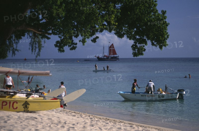 WEST INDIES, Barbados, St James, Holetown. Various boats and tourist water activities beside beach.