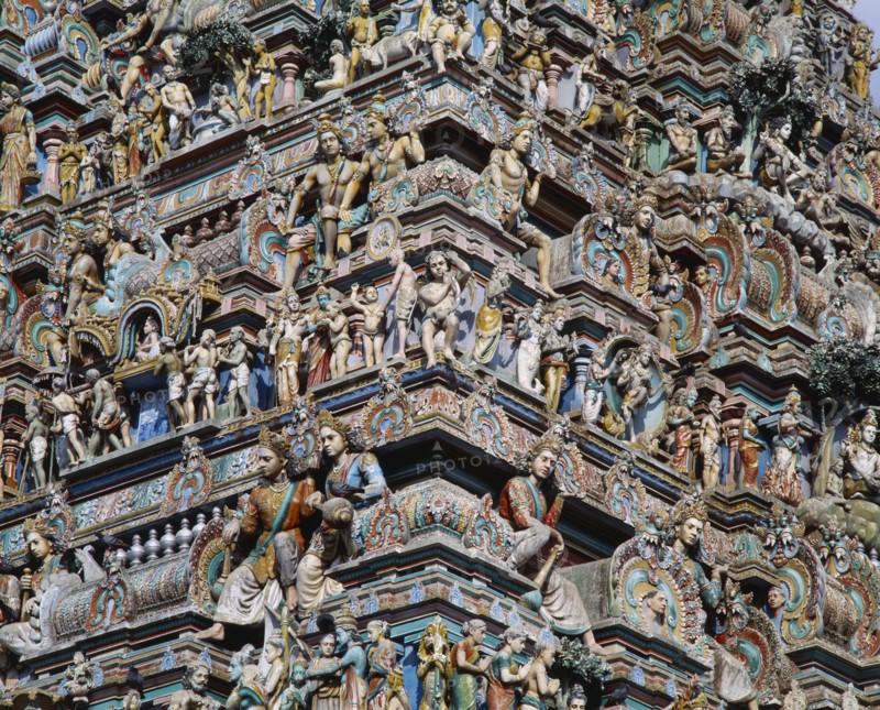 INDIA, Tamil Nadu, Madras, Kapaleeshwara Temple.  Detail of Dravidian style gopuram or pyramidal gateway showing multiple carved figures.