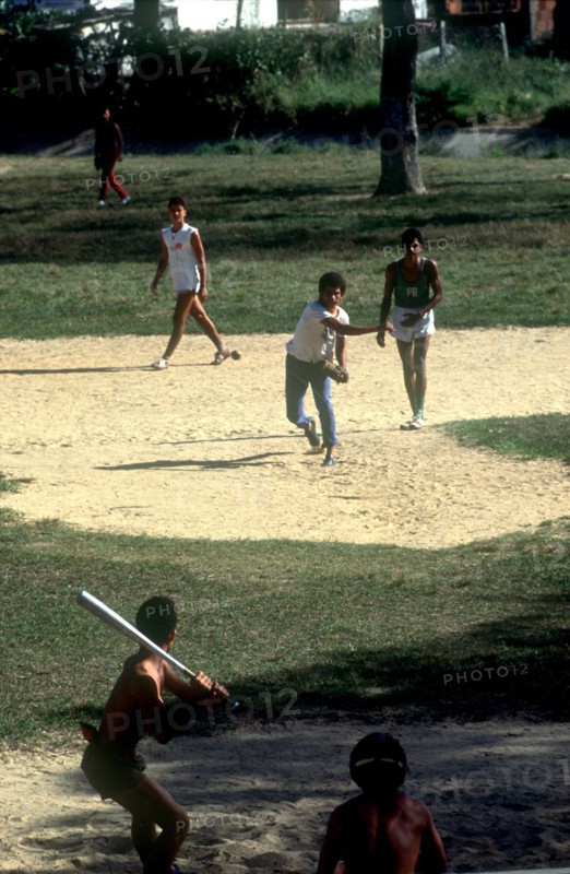 CUBA, Pinar del Rio, Young men playing a game of baseball
