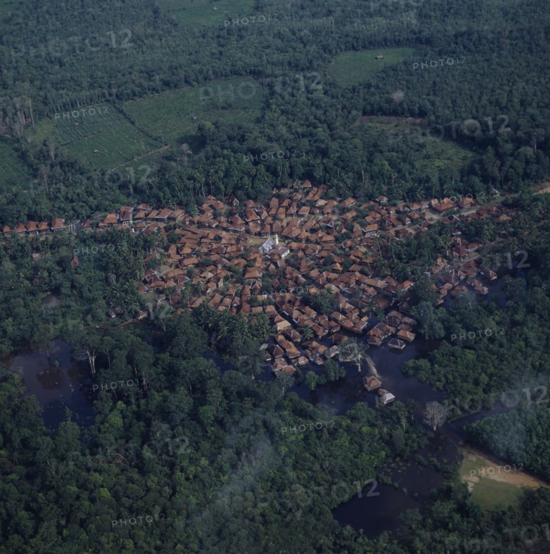 INDONESIA, Sumatra, Aerial view of small town built around a mosque showing radial formation of town
