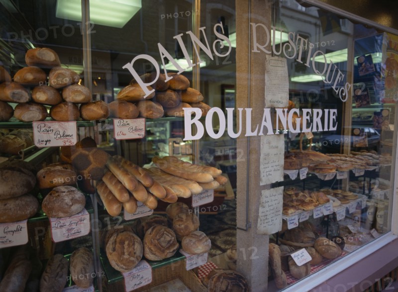 FRANCE, Nord-Picardy, Pas-de-Calais., "Boulogne.  Boulangerie in Haute Ville, part view of exterior with window filled with breads and cakes."