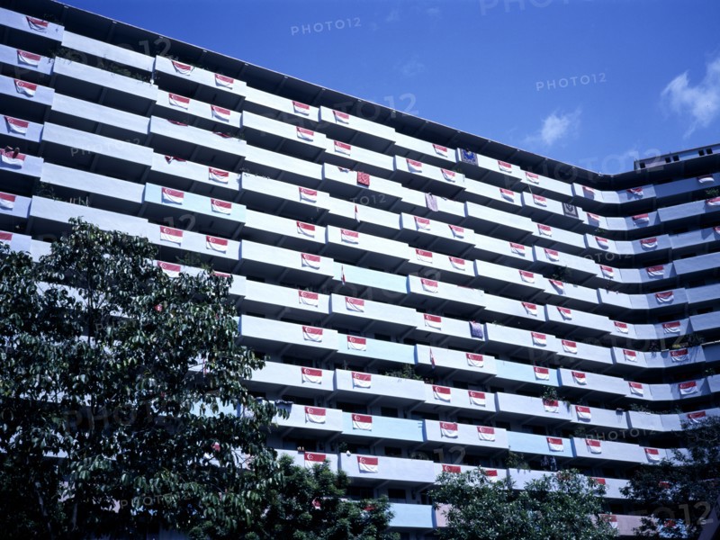 SINGAPORE, Architecture, New housing development of modern multi-storey flats with flag of Singapore hanging from every balcony on National Day.