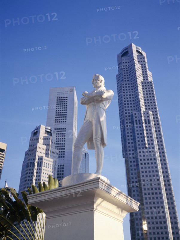 SINGAPORE, Architecture, Statue of Sir Stamford Raffles with high rise buildings in Raffles Place behind.