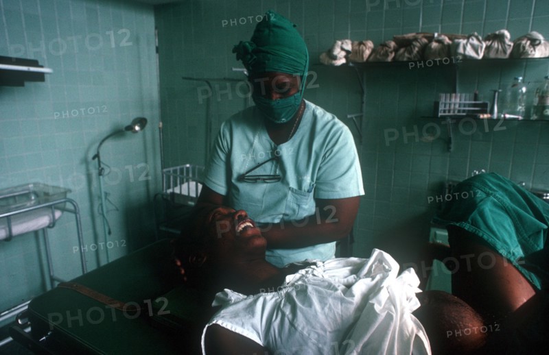 CUBA, Havana, Pregant woman in advanced labour being attended by nurse in the delivery suite