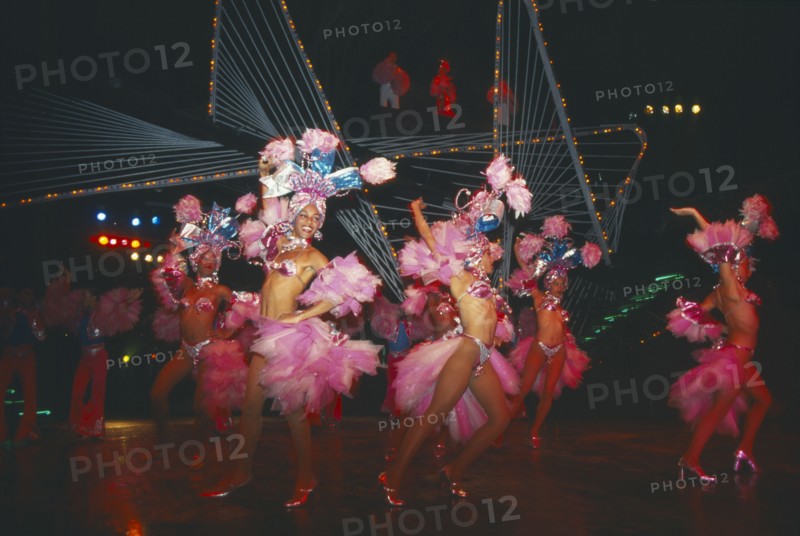 CUBA, Havana Province, Havana, Female Club Tropicana dancers on stage with singers on overhead walkway