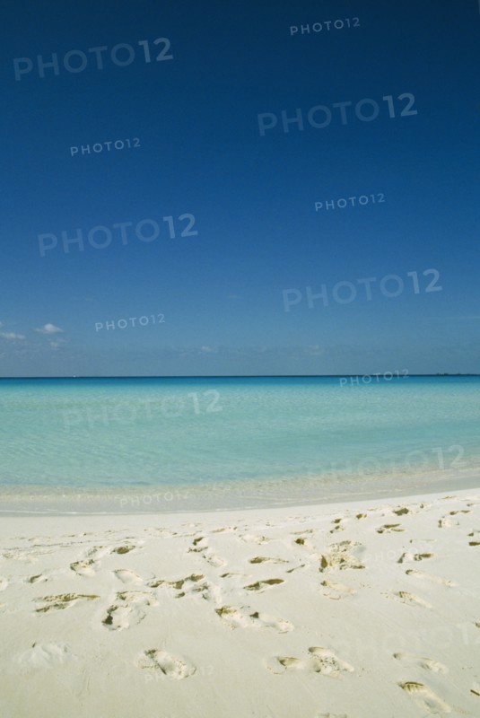 CUBA, Isla De Juventud, Cayo Largo, Playa Serena looking out to sea with footprints in the sand