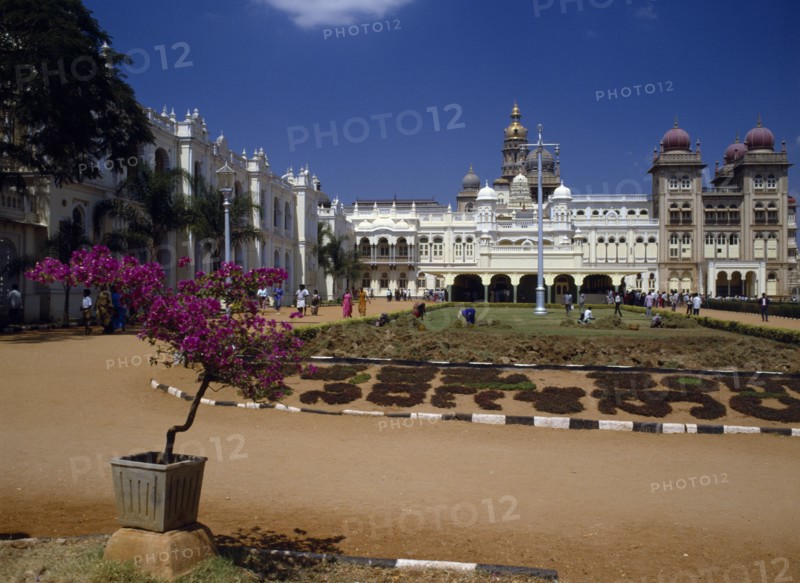 INDIA,  , Mysore, Maharaja’s Palace.  Exterior facade with visitors and people working in grounds.