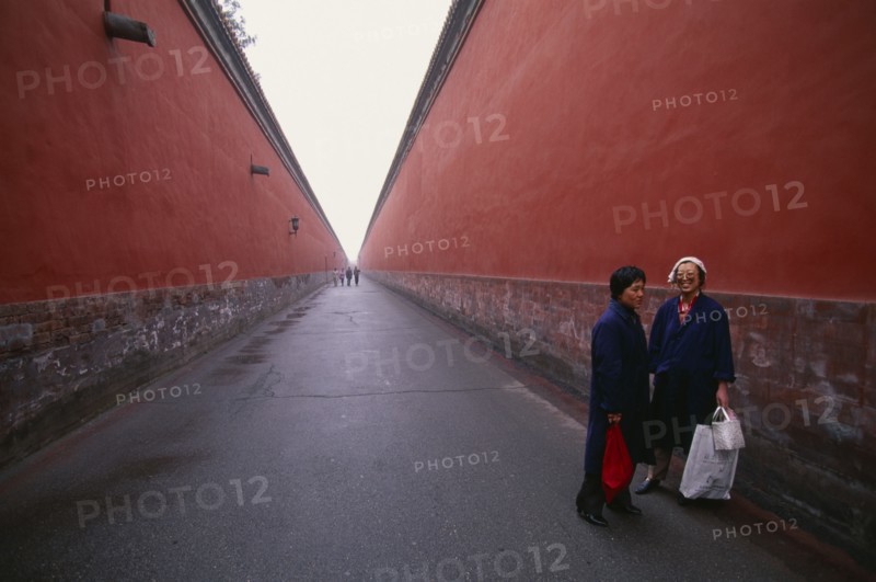 CHINA, Beijing , Imperial Palace, Two women standing between red walls