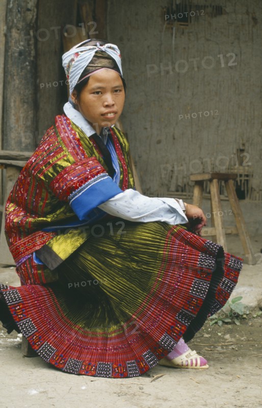 CHINA, Guizhou Miao Girl, Kaili, Seated Miao girl in festival dress