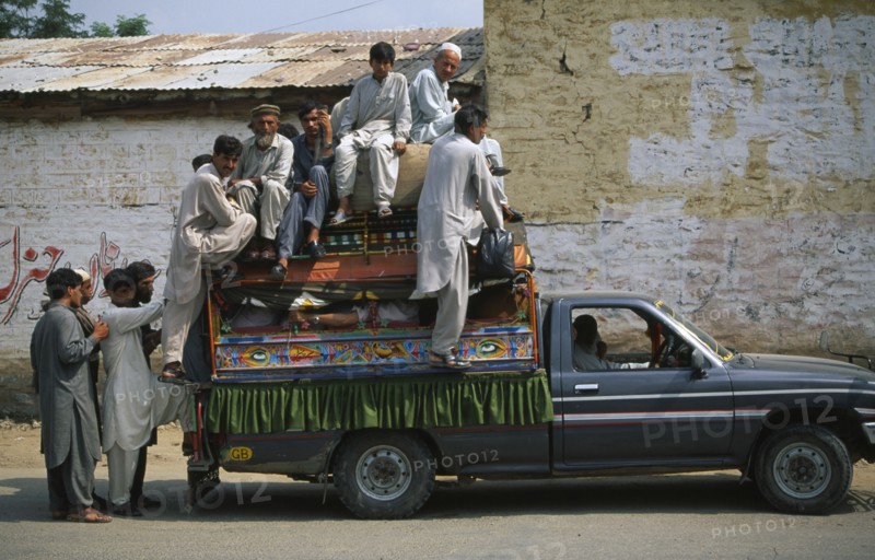 PAKISTAN, NW Frontier Province, Mingaora, Men crowded into and onto roof of truck.