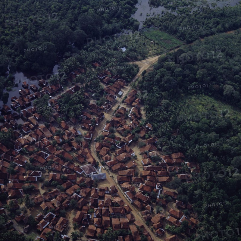 INDONESIA, South, Sumatra, "Aerial view of village,central mosque,wetlands & secondary jungle. Radial development of town"