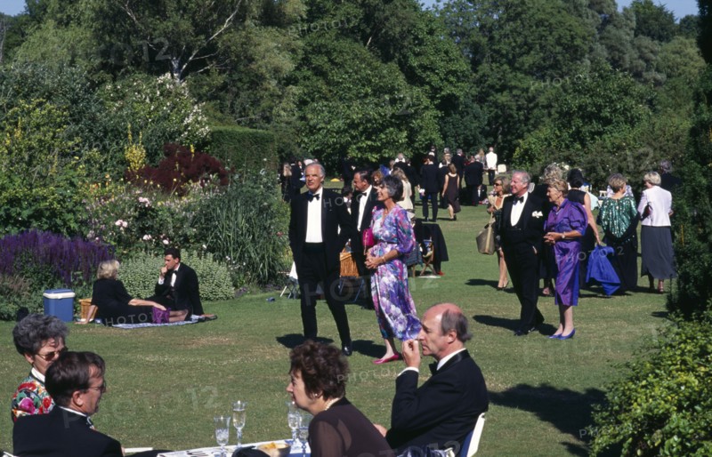 ENGLAND,  East Sussex, Glyndebourne, Opera attendees enjoying picnics in the gardens during performance interval