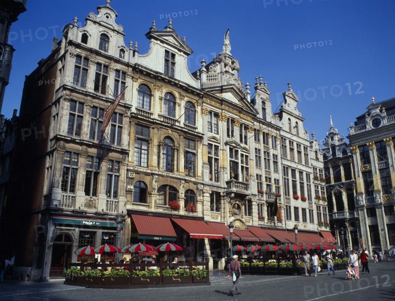BELGIUM, Brussels, Grand Place, Highly decorated buildings in the historic square with outdoor restaurants and umbrellas.