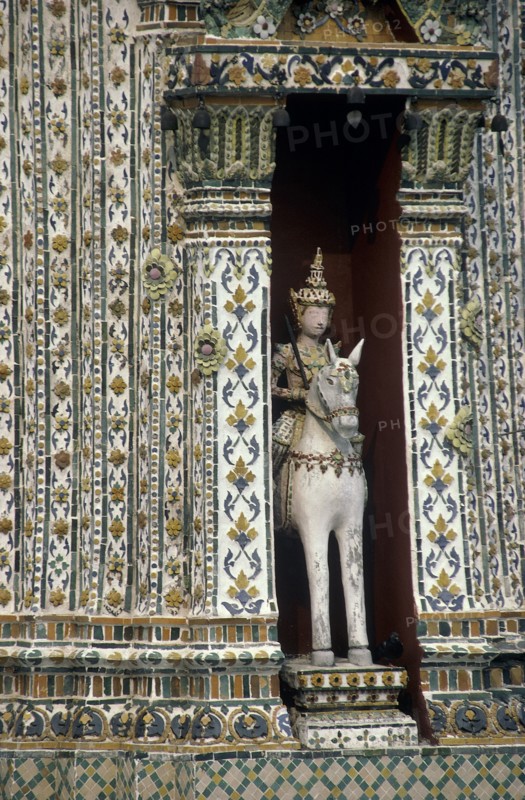 THAILAND, Bangkok, Wat Phra Kaeo close up statue of a horseman set into an alcove of a decorative building