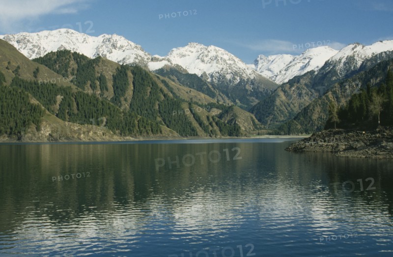 CHINA, Xinjiang , Lake Tianchi, View over the lake toward snow capped mountain peaks