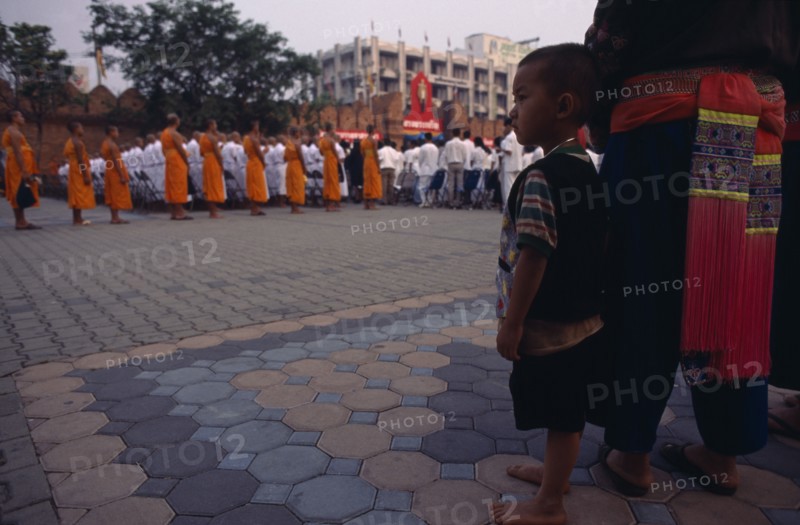 THAILAND, North, Chiang Mai, Child watching ordination of novice monks.