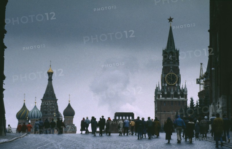 RUSSIA,  , Moscow, Red Square in winter with crowds and spires of St Basils Cathedral and clock tower