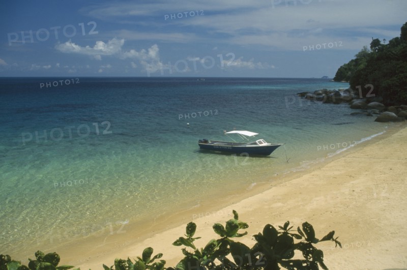 MALAYSIA, East Coast, Pulau Tioman, Small boat moored on the shore of a sandy beach on the west coast of the island.