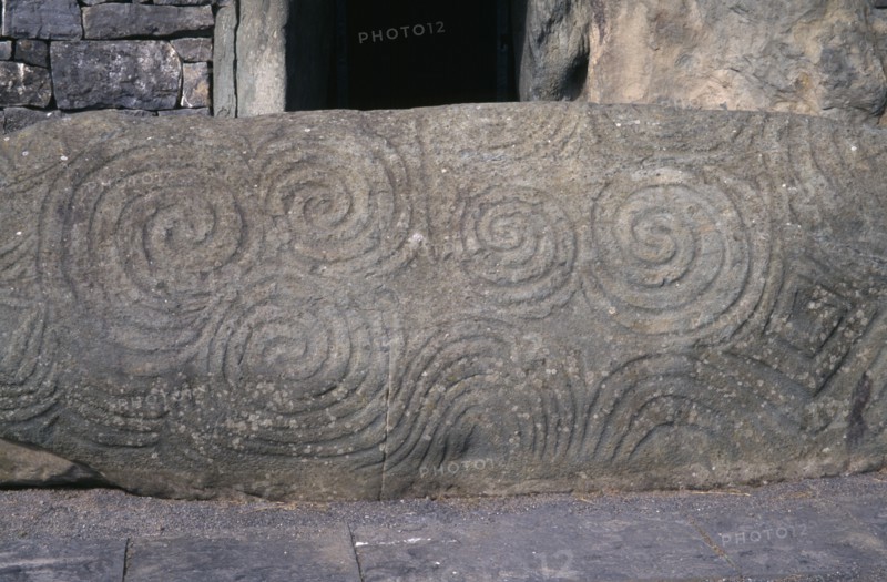 IRELAND, County Meath, Boyne Valley , Newgrange world heritage site. Carved stone at entrance of Prehistoric Burial Site