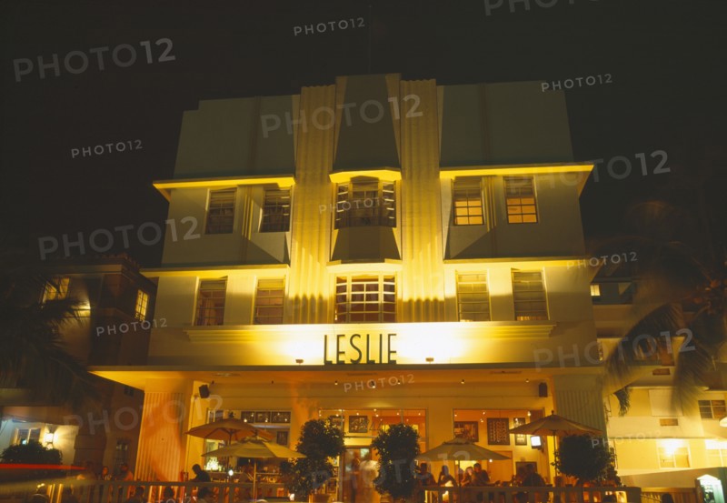 USA, Florida , Miami , South Beach. Ocean Drive Art Deco Buildings at night Leslie Building & diners in restaurant