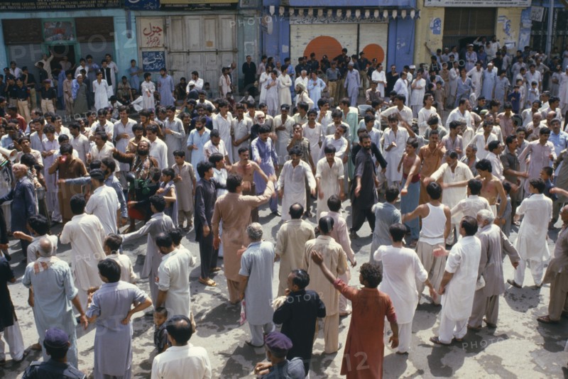 PAKISTAN, N W Frontier Province, Peshawar , "Mohurrum Festival.  Men beating their chests durring Shia muslim festival of mourning to commemorate the death of Husayn ibn Ali, grandson of Muhammad."