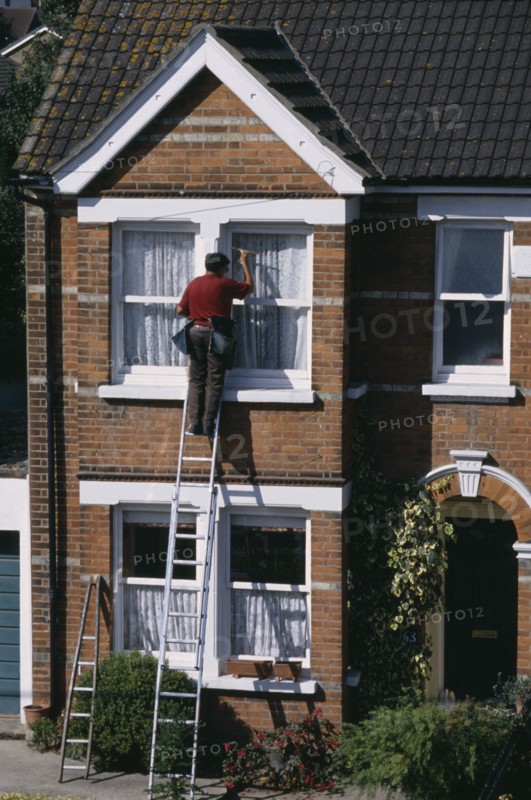 CLEANING, Domestic, Window cleaner on ladder cleaning outside of household windows.