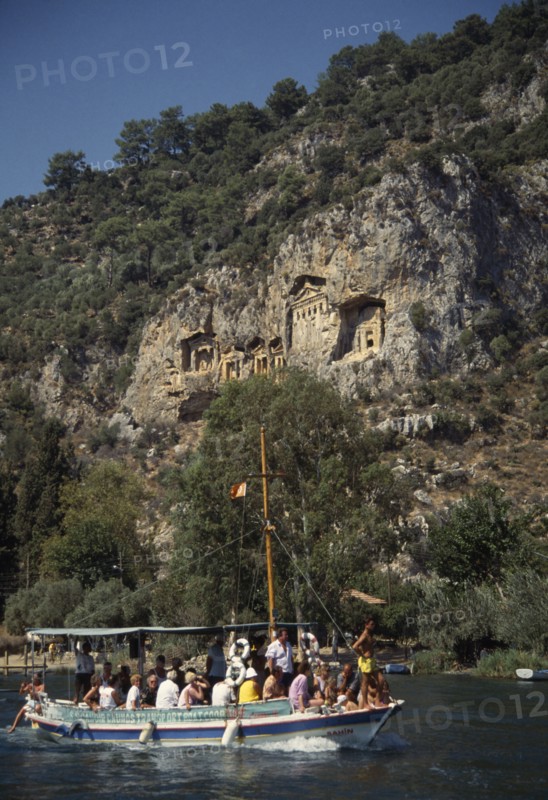 TURKEY, Dalyan, Tourist boat passing rock tombs