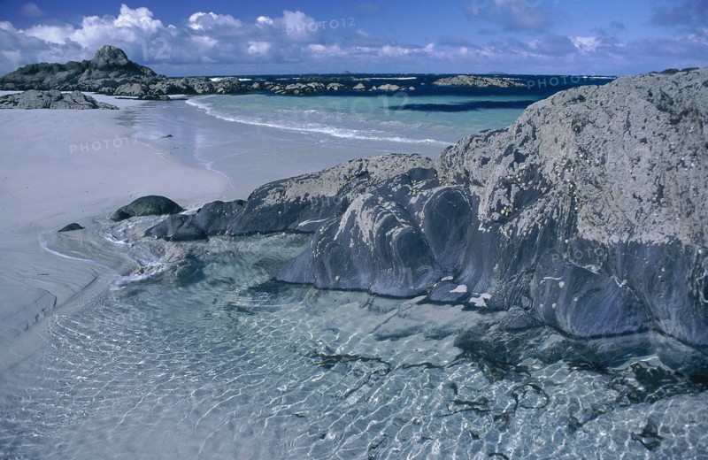 SCOTLAND, Isle Of Iona, White sandy beach with rocks and clear blue water