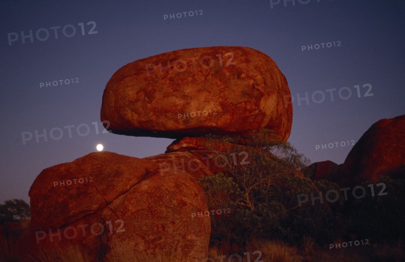 AUSTRALIA, Northern Territory, Devils Marbles, View of the large erroded rock spheres at moonrise