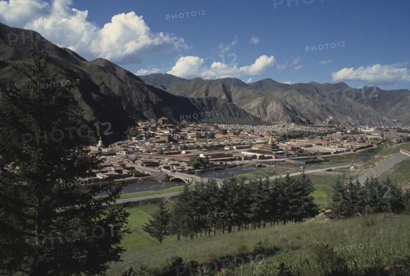CHINA, Gansu, Xiahe, General view over Labrang Monastery from a distance with surrounding hills