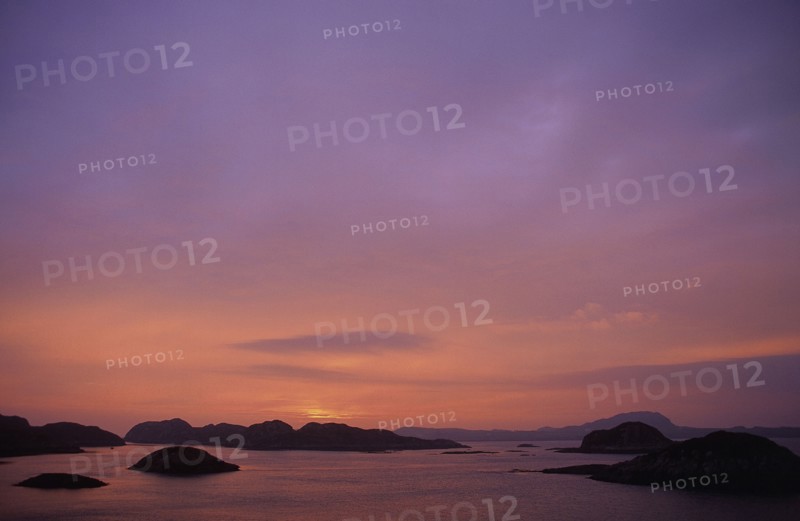 SCOTLAND, Isle Of Iona, View out to sea at sunset over small islands