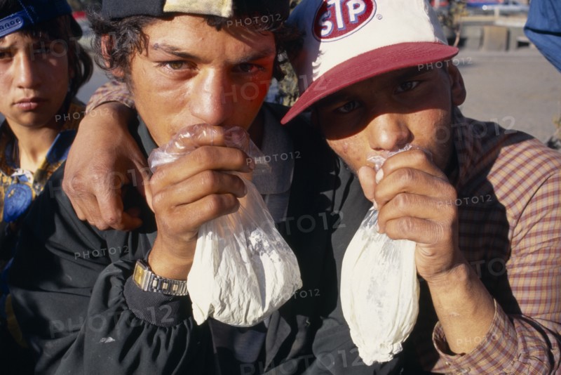 BULGARIA, Sofia, Solvent Abuse. Two gypsy boys sniffing glue from plastic bags