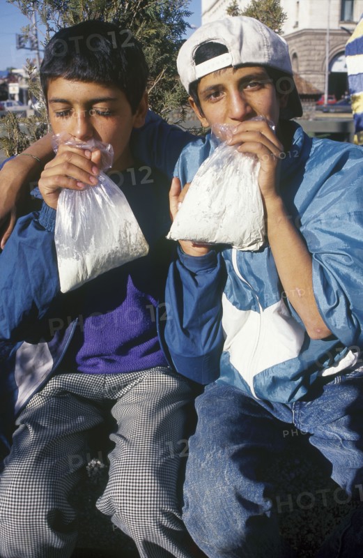 BULGARIA, Sofia, Two gypsy boys sniffing glue from plastic bags
