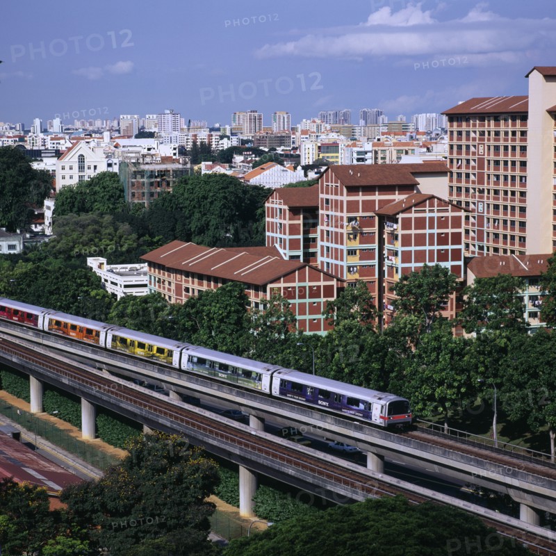 SINGAPORE, Near Kallang, MRT Mass Rapid Transport train with City Skyline and apartment blocks