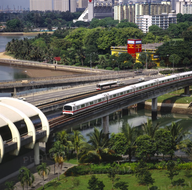 SINGAPORE, MRT Nr Kallang, MRT Mass Rapid Transport Train Nr Kallang Station On Kallang River. Road Traffic On Sir Arthur's Bridge. Apartment Blocks. J6828