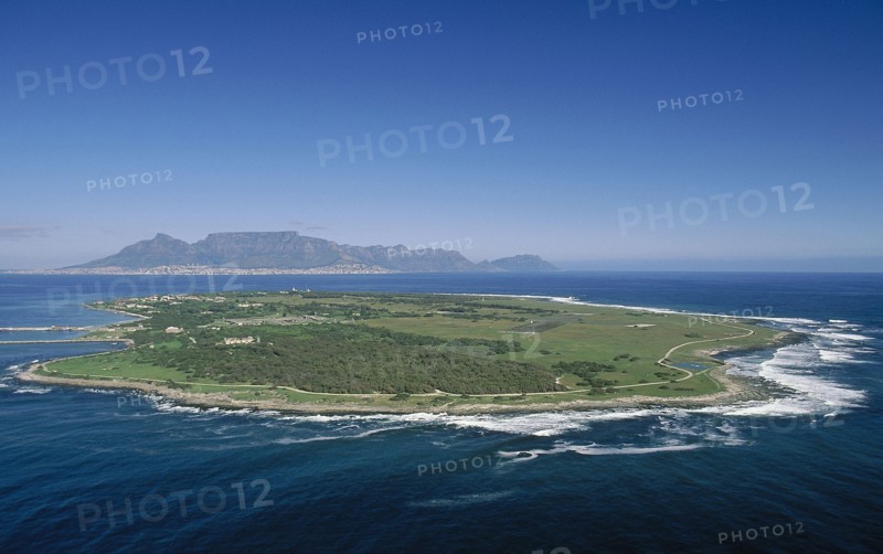 SOUTH AFRICA, Western Cape, Robben Island, Aerial view of the prison island with table Mountain in the distance