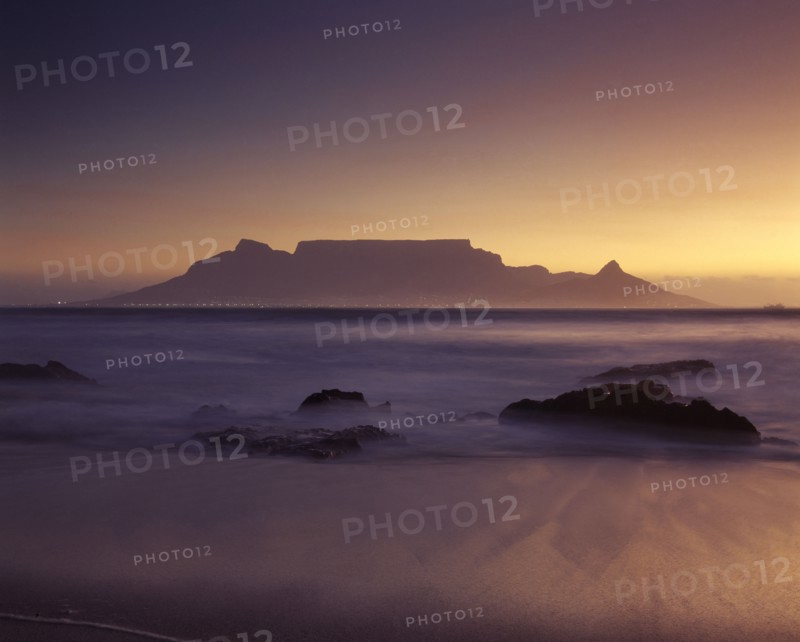 SOUTH AFRICA, Cape Province, Cape Town, View of Table Mountain at dawn taken from Bloubergstrand shore line