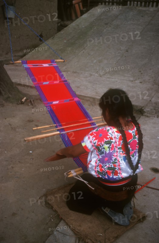 MEXICO, Chiapas, Zinacantan , Near San Cristobal.  Woman weaving.