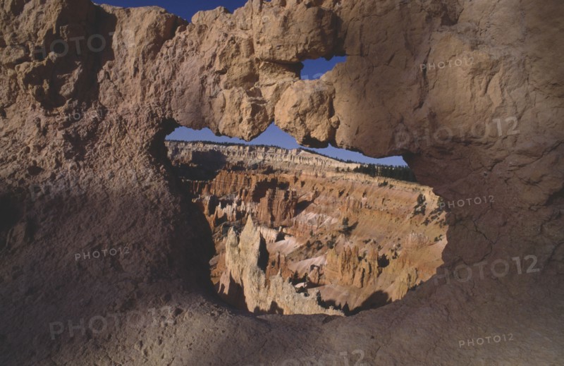 USA, Utah, Bryce Canyon National Park , View through natural arch toward valley of colourful rock pinnacles