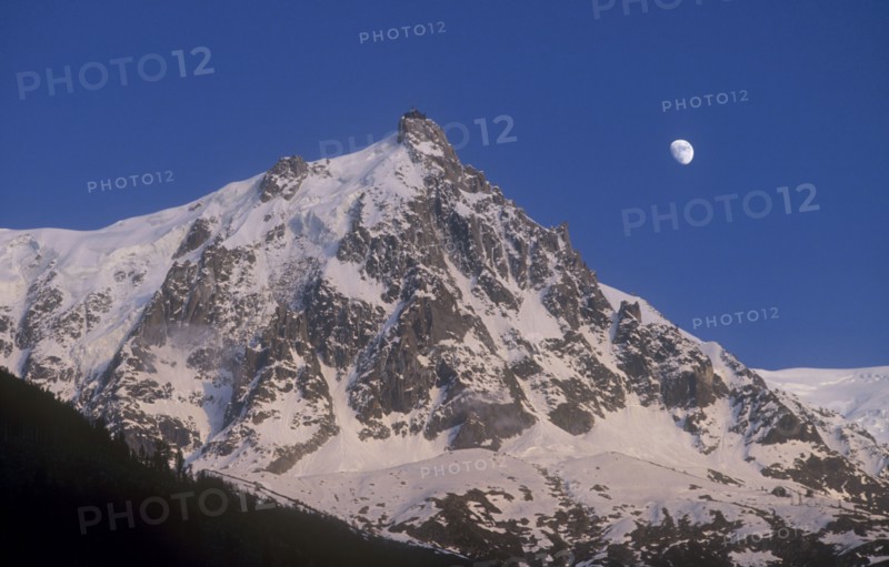 FRANCE, Rhone Alps , Chamonix, Haute Savoie. Snow covered Alps with the Moon in the sky