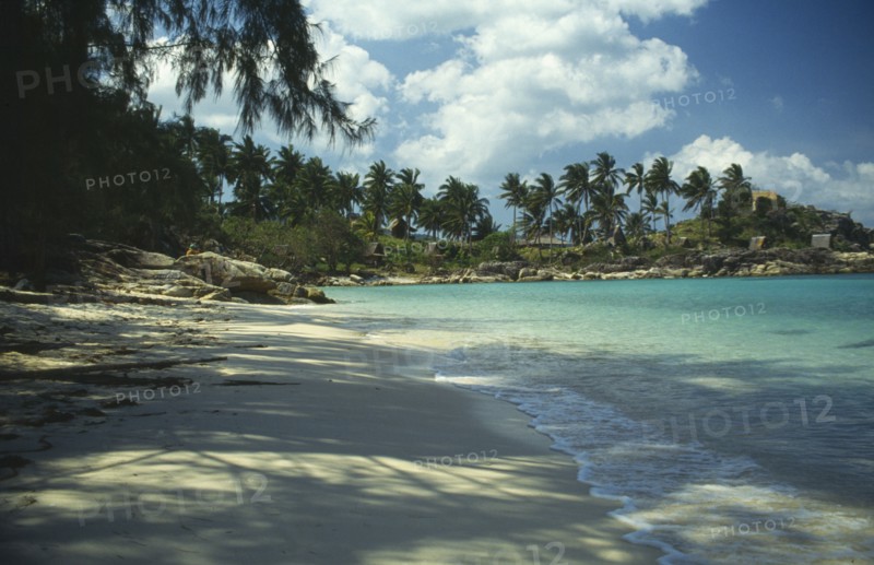 THAILAND, Koh Pha-Ngan Island, Coral Bay.  View along sandy beach toward bay with surrounding rocks lined with palms