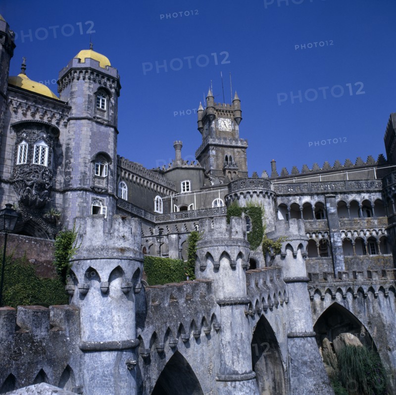 PORTUGAL, Estremadura, Sintra, Pena Palace. View  from castle walls with clock tower and blue sky