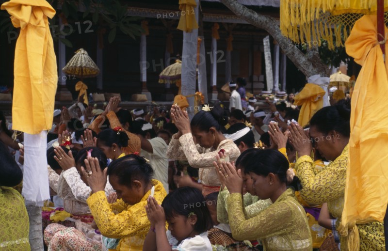 INDONESIA, Bali  , Kuningan Festival. Mas women dressed in yellow at Pura Taman Pule Temple (decorated in yellow)