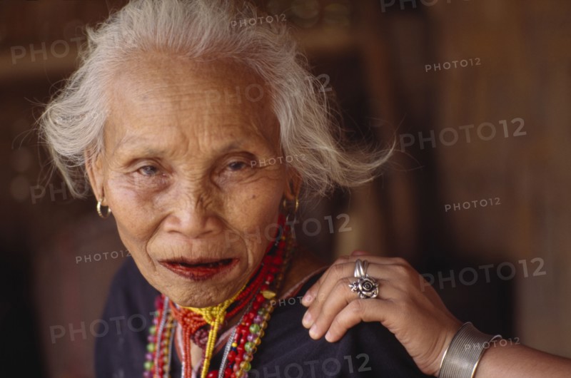 THAILAND, North, Chang Ria, Portrait of an elderly Karen Refugee woman with a younger womans hand on her shoulder