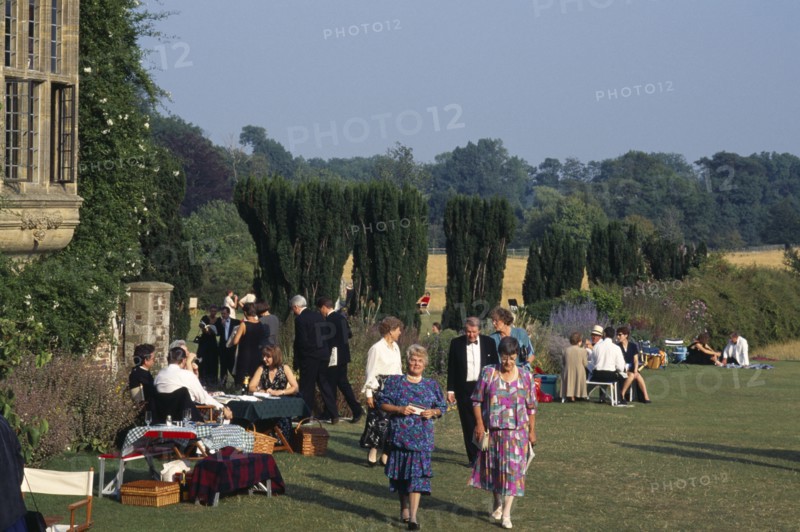 ENGLAND,  East Sussex, Glyndebourne, Opera attendees enjoying picnics in the gardens during performance interval