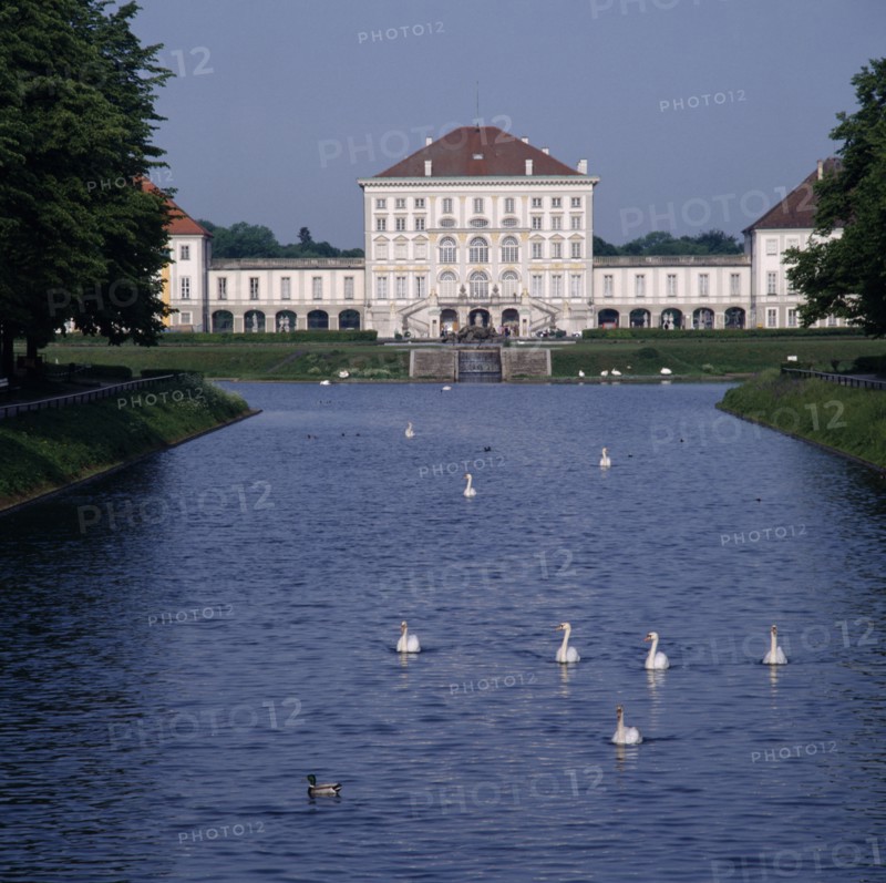 GERMANY, Bavaria , Munich, Schloss Nymphenburg. Viewed from tree lined canal with swans and ducks