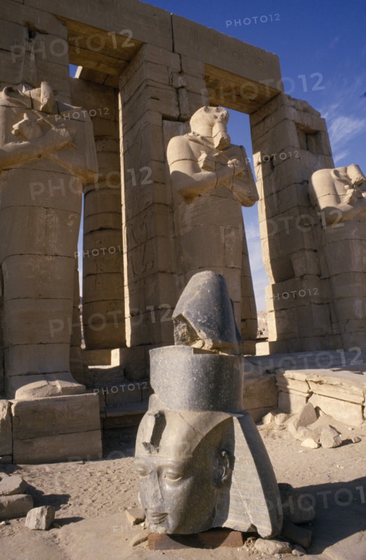 EGYPT,  , Luxor, Osirid columns in front of temple with head of statue on ground