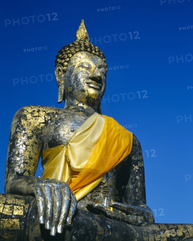 THAILAND, Central Plains, Sukhothai, Satue of buddha on temple-gold and yellow sash